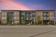 an exterior view of an apartment building on a city street
