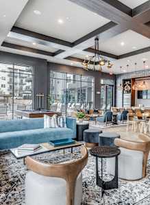 a living room with a pool table and a bar