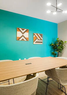 A conference room with a long table and chairs.