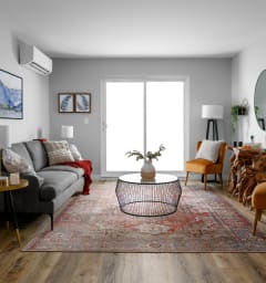 a kitchen and living room with a large island with stools