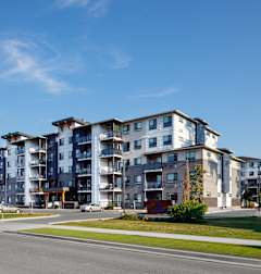 a picture of an apartment building with a blue sky in the background