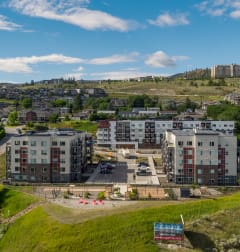 a picture of an apartment building with a blue sky in the background