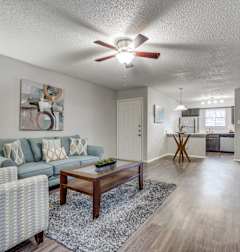 A living room with a couch, chair, and coffee table.