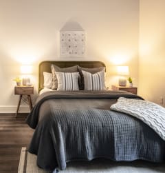 a bedroom with a bed and two night stands with lamps
