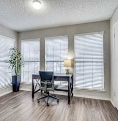 A room with a desk and a chair.