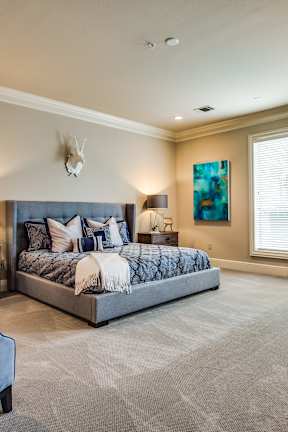 A bedroom with a large bed and a couch.