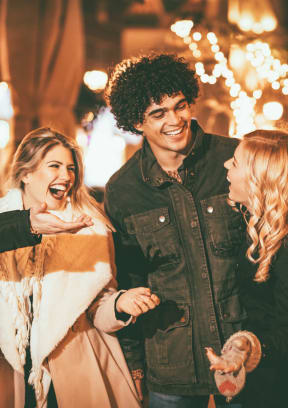 a group of people standing in front of a christmas tree