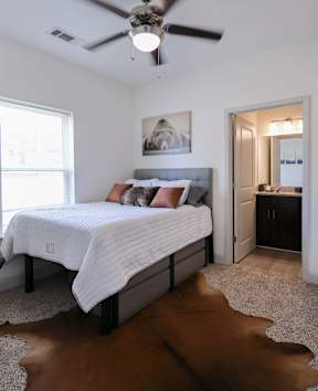 a kitchen with stainless steel appliances and a granite counter top at Midtown Sam Houston Apartments, Huntsville, TX, 77340