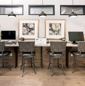 an office with a long desk with two computers on top of it