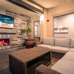 a living room with a couch and a coffee table in front of a fireplace