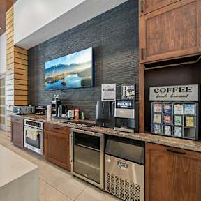 A coffee shop interior with a counter and a television screen.