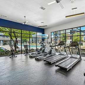 A gym with treadmills and exercise bikes.