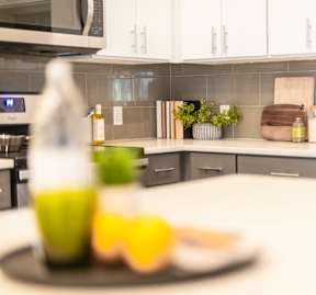 A kitchen counter with a plate of food and a bottle of olive oil.