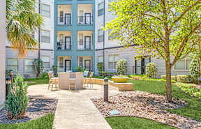 A modern apartment complex with a well-maintained courtyard.