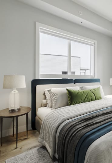 a bedroom with a large bed and two windows