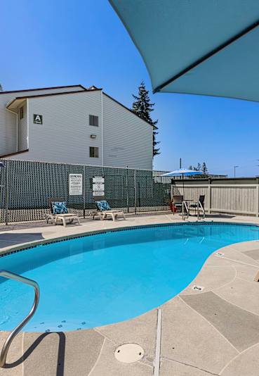 Pool With Relaxing Chairs at Campo Basso Apartment Homes, Lynnwood, 98087