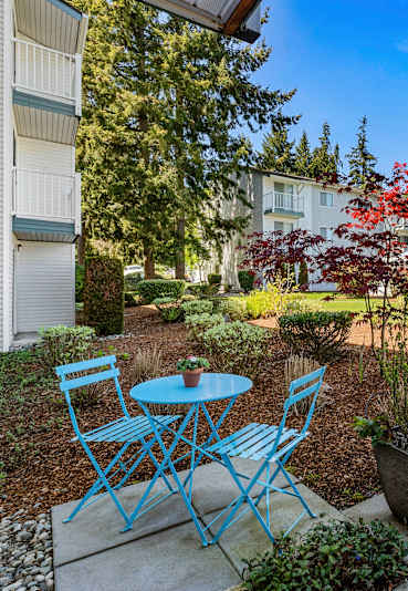 a patio with a table and chairs in front of a building at Park 212 Apartment Homes, Edmonds, WA, 98026