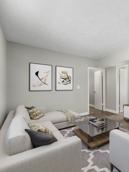 a living room with a couch and a table at Pines at Lawrenceville Apartments in Decatur, Georgia 30033