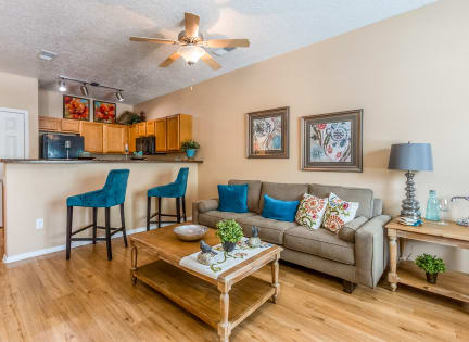 a living room and kitchen with a couch and a coffee table