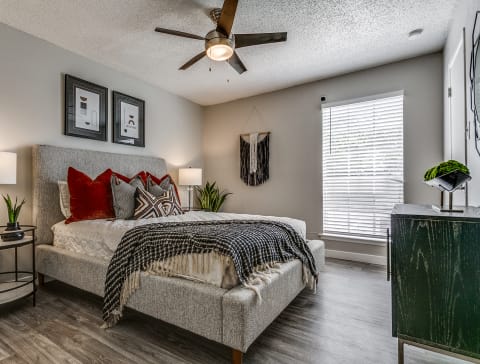 a bedroom with a bed and a ceiling fan