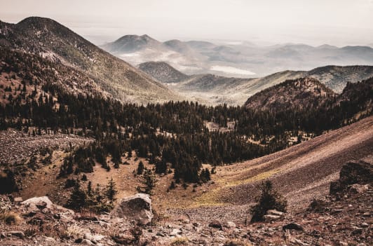 a view of a mountain range and a mountain valley