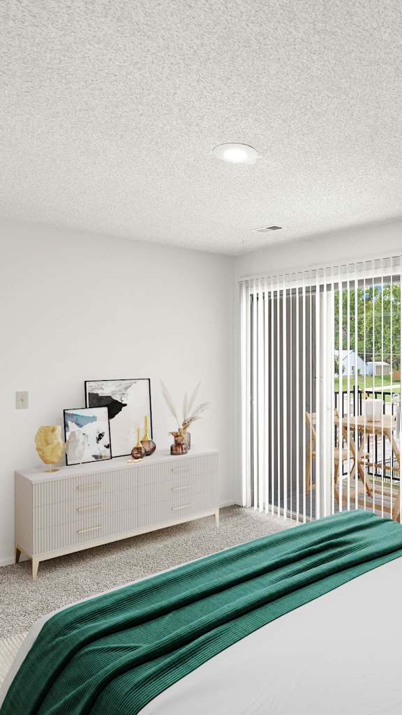 A bedroom with a bed, a couch, and a television.