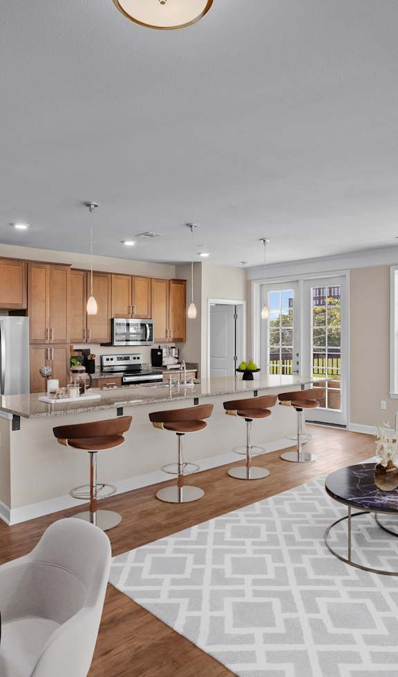 a living room and kitchen with a large window at The Dorset, Kansas City, 64112