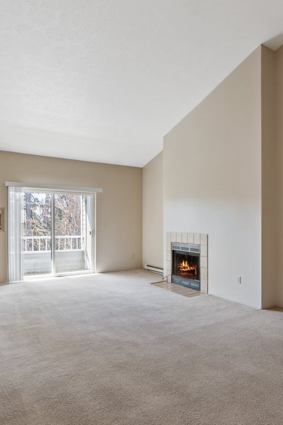 the living room of an empty house with a fireplace
