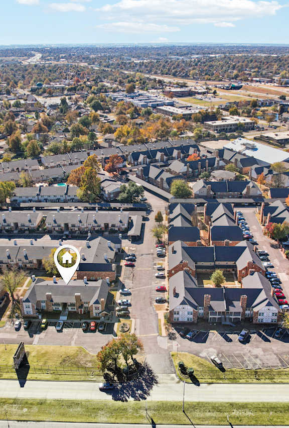 A bird's eye view of a residential area with houses and cars.