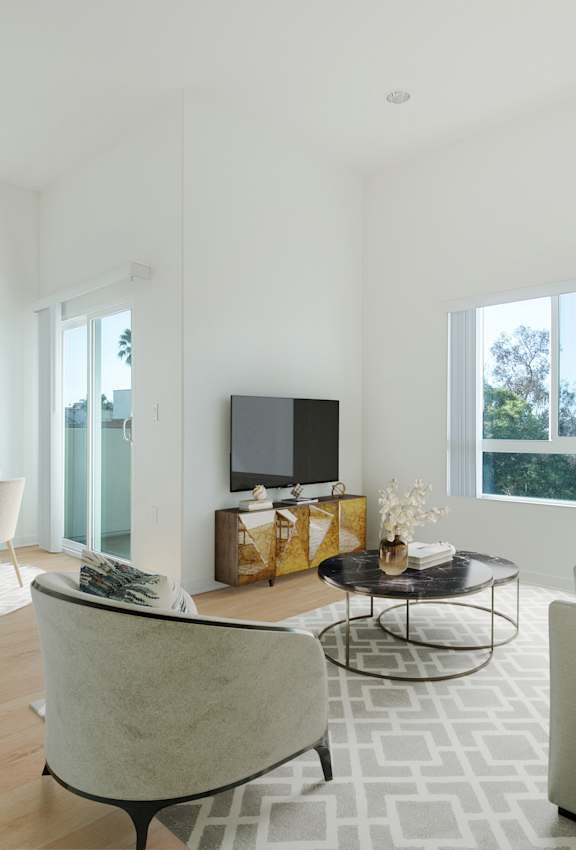 A modern living room with a large couch, a chair, a coffee table, and a television.