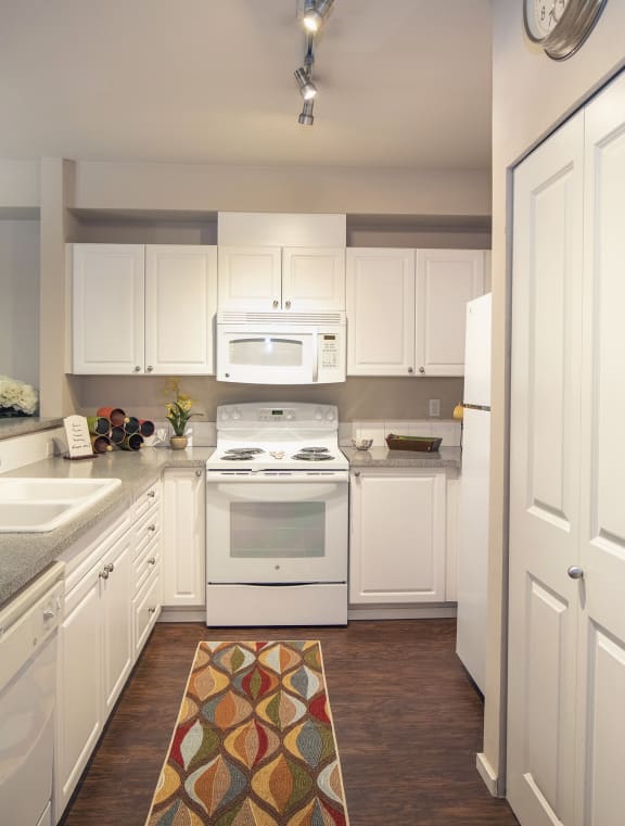 Kitchen with White Appliances at Metropolitan Place Apartments Renton, WA