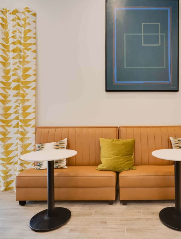 a seating area with a couch and two tables at Station JTown, Kentucky, 40299