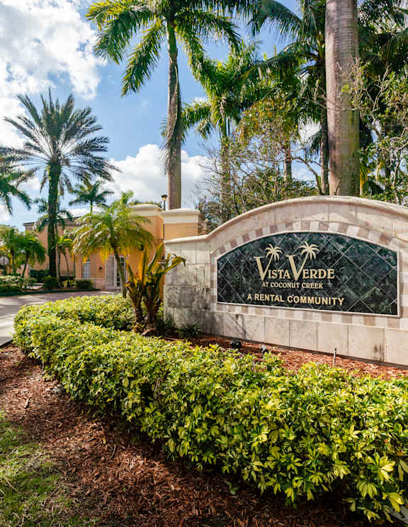 A sign that says Vista Verde Apartment Community in front of a building.