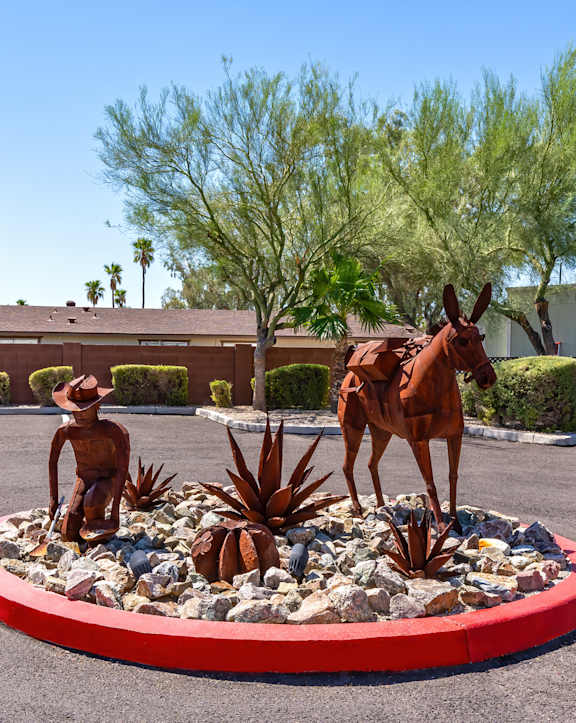 a statue of a horse and a man in a round garden