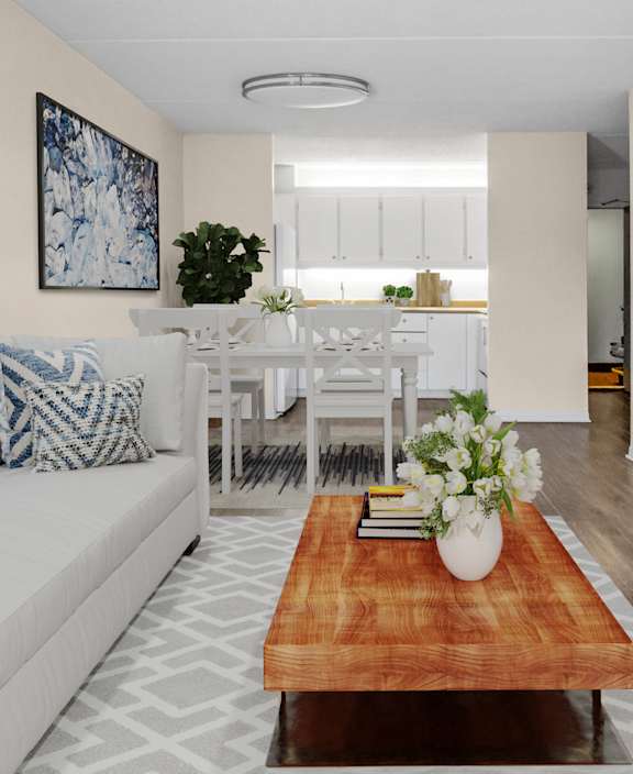 A living room with a white couch and a dining table.