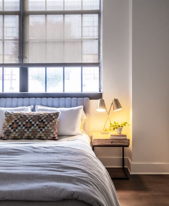 a bedroom with a bed and a window