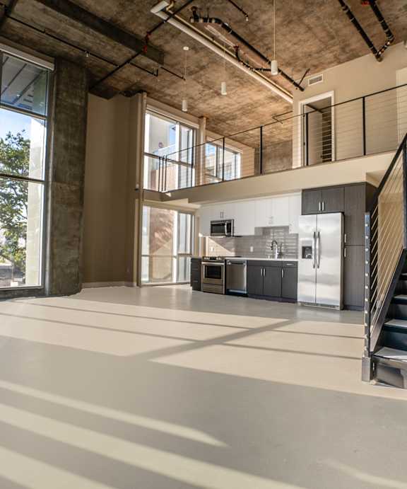 A large open space with a staircase leading to the upper floor.
