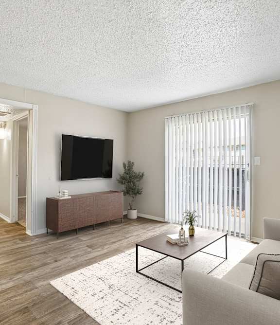 A living room with a black leather couch and a wooden coffee table.