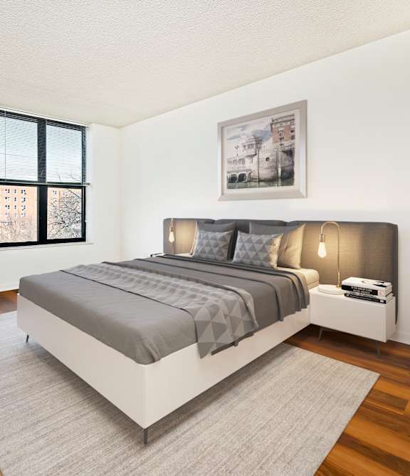A bedroom with a large bed and a window.