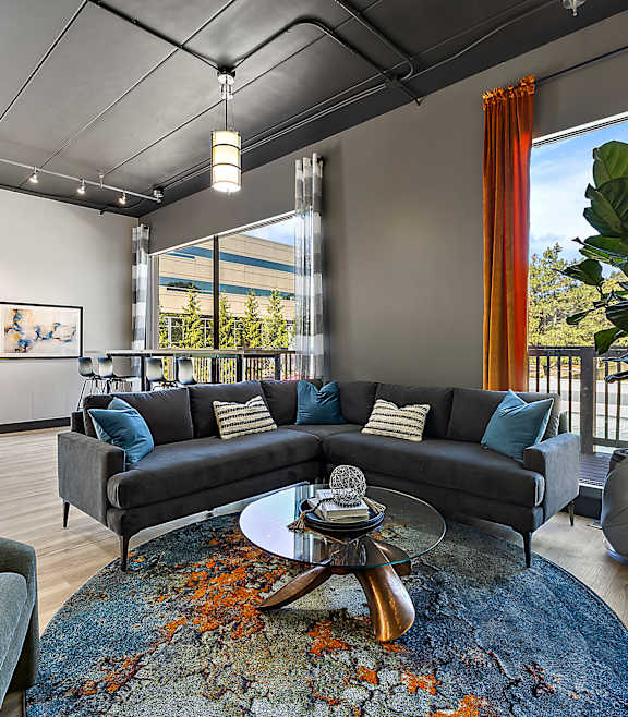 A living room with a grey couch and a coffee table.