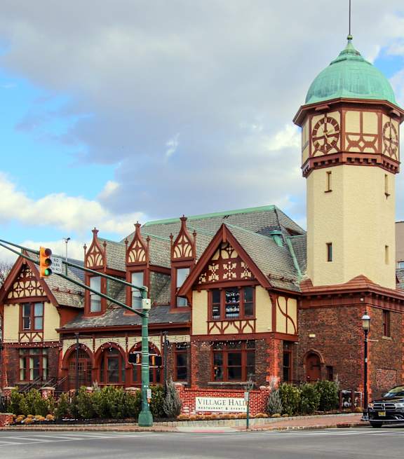 A building with a green dome and a clock tower.