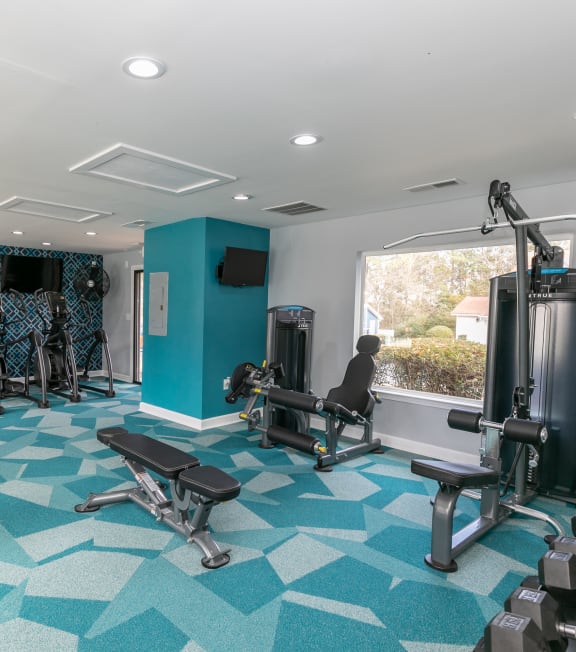 a gym with exercise equipment and a window