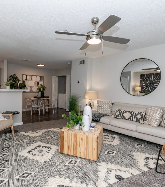 a living room with a couch and a ceiling fan