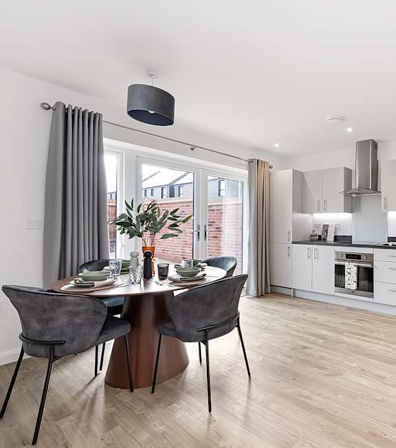 a living room with a couch and a table at The Woodlands Apartments, Milton Keynes, MK5 6GS
