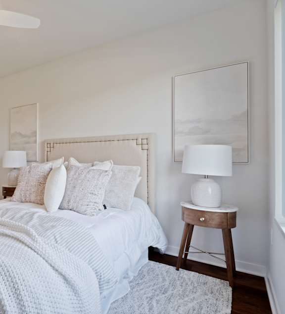 a bedroom with a large bed and a ceiling fan