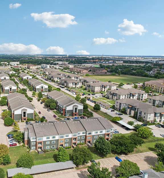 A bird's eye view of a residential area with houses and trees.