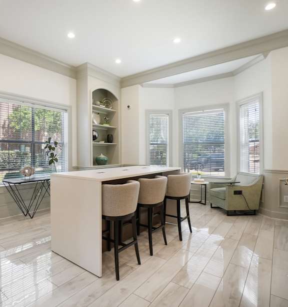 A kitchen with a dining table and chairs.