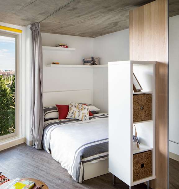 A bedroom with a large bed and a couch.