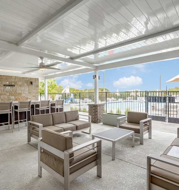A patio with a white ceiling and furniture.