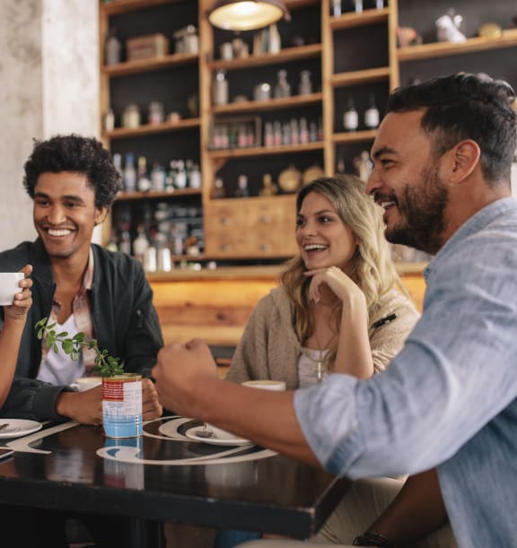 a group of people sitting at a table in a restaurant at The Granite Works Apartments , Buffalo, 14202